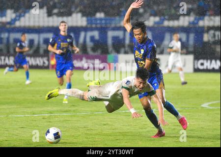 Bandung, Indonésie. 5 décembre 2024. Mohammad Edo Febriansyah (R) de Persib Bandung affronte Wang Yudong de Zhejiang FC lors du match de football du groupe F de la Ligue des champions de l'AFC entre l'indonésien Persib Bandung et le chinois Zhejiang FC à Bandung, Indonésie, le 5 décembre 2024. Crédit : Septianjar Muharam/Xinhua/Alamy Live News Banque D'Images