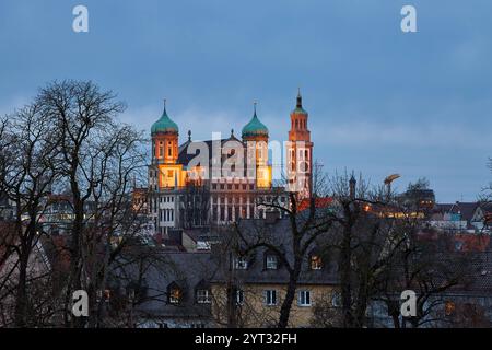 Augsbourg, Bavière, Allemagne - 5 décembre 2024 : L'hôtel de ville historique d'Augsbourg, un point de repère de la ville, brille par une lumière chaude au crépuscule. Les dômes d'oignon frappants et l'architecture impressionnante en font l'un des sites les plus importants du centre-ville d'Augsbourg. *** Das historische Rathaus Augsburg, ein Wahrzeichen der Stadt, erstrahlt in warmem Licht während der Abenddämmerung. Die markanten Zwiebeltürme und die beeindruckende Architektur machen es zu einem der bedeutendsten Sehenswürdigkeiten Augsburgs in der Innenstadt / Zentrum. Banque D'Images