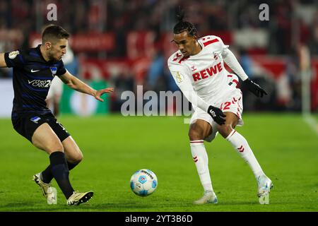 Cologne, Allemagne. 04th Dec, 2024. Football : DFB Cup, 1. FC Köln - Hertha BSC, manche 16, RheinEnergieStadion, Berlin Jonjoe Kenny contre le Damion Downs de Cologne crédit : Christoph Reichwein/dpa - NOTE IMPORTANTE : conformément aux règlements de la DFL German Football League et de la DFB German Football Association, il est interdit d'utiliser ou d'avoir utilisé des photographies prises dans le stade et/ou du match sous forme d'images séquentielles et/ou de séries de photos de type vidéo./dpa/Alamy Live News Banque D'Images