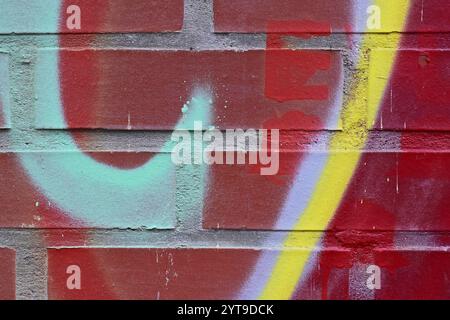 Graffiti coloré sur un mur de briques Banque D'Images