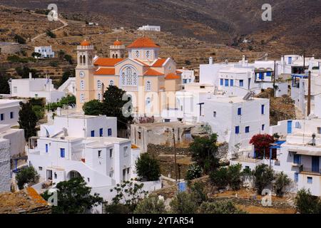 Tinos : église orange, bâtiments blancs et terrasses brunes de Pyrgos (Panormos), Tinos, île des Cyclades, Grèce Banque D'Images