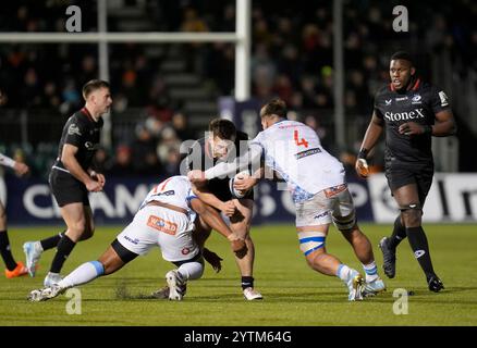 Theo Dan des Saracens (au centre) est affronté par Alulutho Tshakweni des Vodacom Bulls (à gauche) et Ruan Vermaak (à droite) lors du match de la Coupe des Champions Investec au StoneX Stadium de Londres. Date de la photo : samedi 7 décembre 2024. Banque D'Images