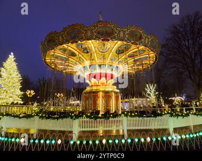 Copenhague, Danemark - 9 décembre 2023 : le carrousel du parc d'attractions Tivoli Gardens dans les lumières de Noël Banque D'Images