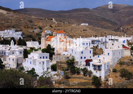 Tinos : église orange, bâtiments blancs et terrasses brunes de Pyrgos (Panormos), Tinos, île des Cyclades, Grèce Banque D'Images