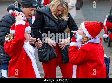 Edimbourg, Écosse, Royaume-Uni, 8 décembre 2024. Christmas Santa Run : le Santa Fun Run & Walk d'Édimbourg célèbre 20 ans de course, de jogging ou de marche autour d'un circuit de 2,5 km dans les jardins de West Princes Street. L'événement collecte des fonds pour When You Wish Upon a Star avec environ 400 participants. Photo : les enfants s'amusent à s'habiller dans leurs costumes de Père Noël. Crédit : Sally Anderson/Alamy Live News Banque D'Images