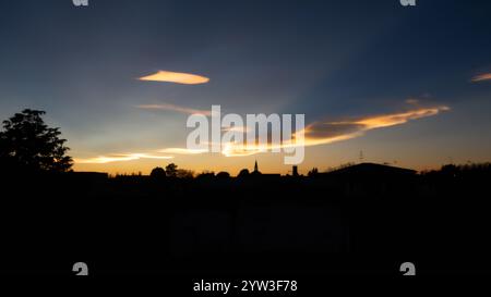 nuages irisés lors d'un beau coucher de soleil hivernal sur la ville. Banque D'Images