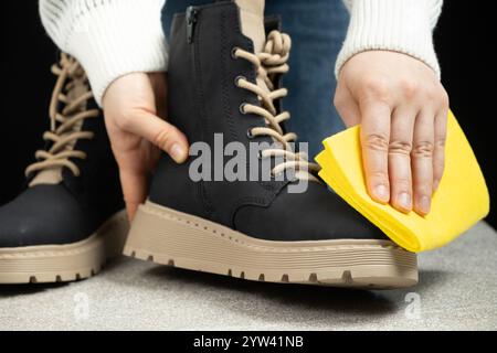 Entretien des chaussures, femme essuyant la surface en tissu de la chaussure en cuir Banque D'Images