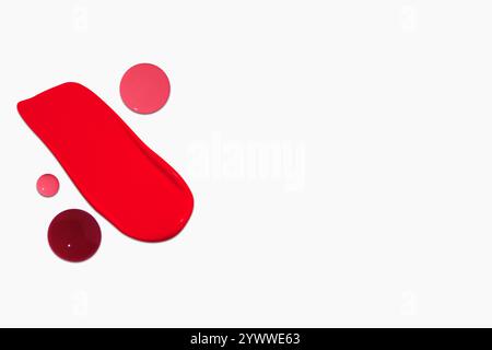 Composition de frottis et gouttes de rouge à lèvres dans différentes nuances, y compris rouge foncé, rouge clair, Bordeaux et rose, isolé sur un fond clair. Banque D'Images