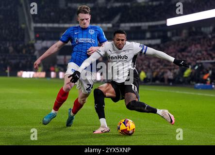 Terry Devlin de Portsmouth (à gauche) et Nathaniel Mendez-Laing de Derby County (à droite) se battent pour le ballon lors du Sky Bet Championship match au Pride Park Stadium, Derby. Date de la photo : vendredi 13 décembre 2024. Banque D'Images