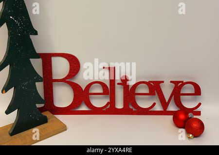Le mot croire à côté d'un arbre de Noël sculpté avec un fond blanc propre sans couture Banque D'Images