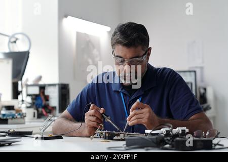 Portrait d'un homme travaillant sur l'électronique en laboratoire Banque D'Images