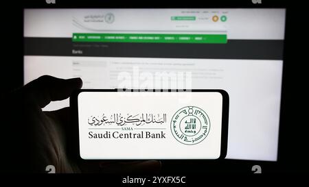 Allemagne. 14 juin 2024. Dans cette illustration photo, une personne tient un téléphone portable avec le logo de l'institution financière Saudi Central Bank (SAMA) devant la page Web. (Crédit image : © timon Schneider/SOPA images via ZUMA Press Wire) USAGE ÉDITORIAL SEULEMENT ! Non destiné à UN USAGE commercial ! Banque D'Images