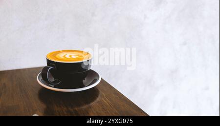 tasse à café blanche placée sur une table en bois près d'une fenêtre lumineuse, capturant un moment serein de simplicité moderne et de lumière naturelle. Parfait pour les vacances pr Banque D'Images