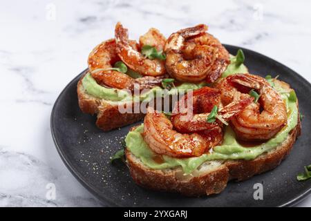 Sandwichs à l'avocat et aux crevettes caramélisées, micro-légumes verts, petit déjeuner, sur une assiette, vue de dessus, fait maison, pas de gens Banque D'Images