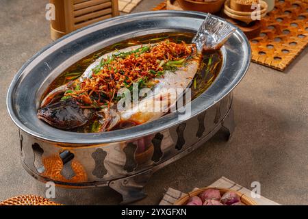 Poisson-chat à la vapeur à la hongkongaise au gingembre, aux oignons verts et à la sauce soja (Indonésie : Ikan patin Steam Hongkong) Banque D'Images