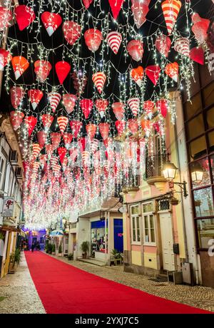 Águeda, Portugal - 27 novembre 2024 : vue nocturne sur la rue du centre-ville de Águeda au Portugal avec décorations de Noël et lumières suspendues. Banque D'Images