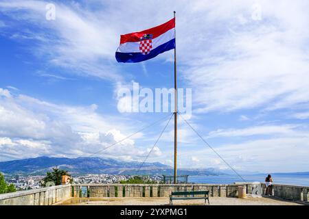 Split, Croatie - 20 septembre 2024 : une femme et un homme près d'un grand drapeau croate sur un grand mât sur la colline de Marjan, Split, Croatie Banque D'Images