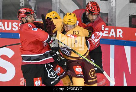 Bremerhaven, Allemagne. 17 décembre 2024. Hockey sur glace : Ligue des Champions, Pinguins Bremerhaven - Servette Genève, finale, quarts de finale, deuxième manche. Nino Kinder de Bremerhaven (à gauche) et Anders Grönland (à droite) affrontent Yoann Imesch de Genève. Crédit : Stringer/dpa/Alamy Live News Banque D'Images