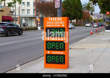 Brea, CA, USA - 25 novembre 2024 : un orange parking garage Spaces disponible signe numérique électronique dans le centre-ville de Brea, Californie. Banque D'Images