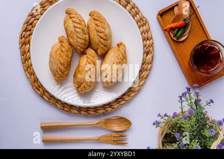 Curry puff ou Pastel goreng. c'est une petite tarte composée de curry avec du poulet et des pommes de terre dans une coquille de pâtisserie frite ou cuite au four Banque D'Images