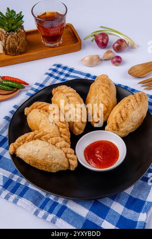 Curry puff ou Pastel goreng. c'est une petite tarte composée de curry avec du poulet et des pommes de terre dans une coquille de pâtisserie frite ou cuite au four Banque D'Images