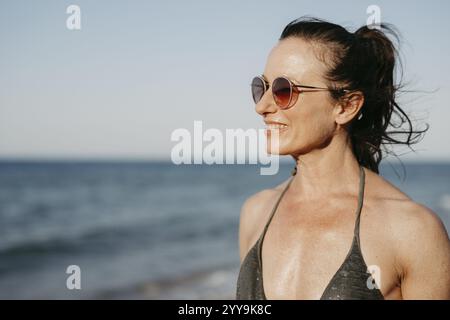 Femme avec des lunettes de soleil en bikini sur la plage, Grèce, Europe Banque D'Images