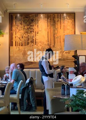 Magasin de thé Betty à Ilkley Yorkshire Angleterre nourriture manger l'après-midi tasse de thé soucoupe crème scones petits pains gâteaux serveuse à l'intérieur du stand magasin personne Banque D'Images