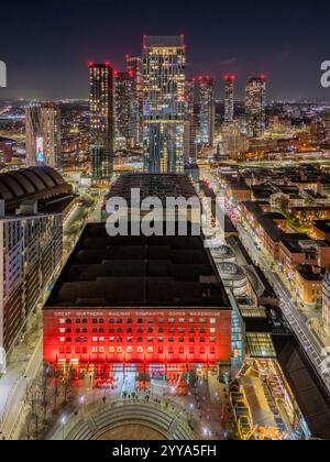 Le centre-ville de Manchester illuminé après la tombée de la nuit, mettant en valeur la skyline, le quartier commerçant et les rues animées du nord de l'Angleterre. Banque D'Images