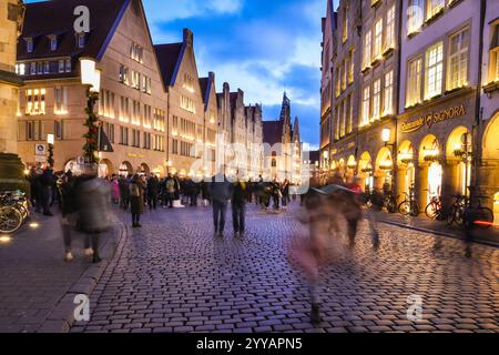 Münster, NRW, Allemagne, 20 décembre 2024. Le célèbre boulevard Prinzipalmarkt est fermé à la circulation et très fréquenté par les visiteurs. Münster (Muenster) et ses cinq marchés de Noël sont animés par des foules de visiteurs festifs de toute la NRW, ainsi que des pays-Bas et d'ailleurs ce soir. Des milliers de personnes affluent vers les marchés traditionnels du pittoresque centre-ville historique. Une sécurité renforcée est visible, les voies d'accès sont limitées, les espaces entre les rues et les marchés ont été bloqués avec des sacs de sable en acier ou en béton et d'autres mesures. Ce soir, une attaque a été menée à Magdebourg Christmas Banque D'Images