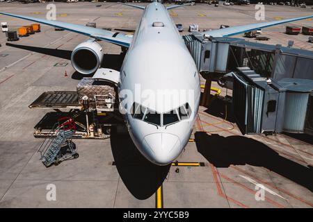 Vue de face de l'avion à l'aéroport le jour ensoleillé. Préparation de l'avion de passagers avant le vol. Banque D'Images