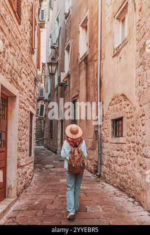 Jeune femme avec sac à dos marchant dans une rue étroite explorant la vieille ville européenne Banque D'Images