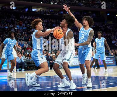 Le garde Tar Heels de Caroline du Nord Seth Trimble (7) retire la balle du garde des Bruins de l'UCLA Sebastian Mack (12) lors de la CBS Sports Classic au Madison Square Garden à New York le samedi 21 décembre 2024. Duncan Williams/CSM Banque D'Images