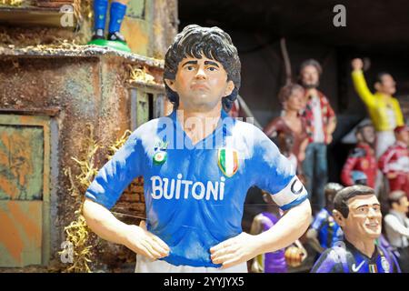 Naples, Italie - 12 décembre 2024 : figurine artisanale de Maradona à San Gregorio Armeno, la célèbre rue des scènes de la nativité de Naples. Banque D'Images
