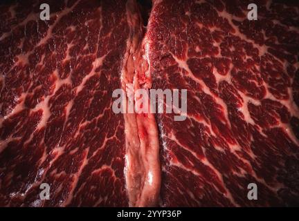 Fond avec la texture du steak de bœuf marbré cru. Gros plan sur la viande de bœuf. Espace pour le texte. Photo de haute qualité Banque D'Images