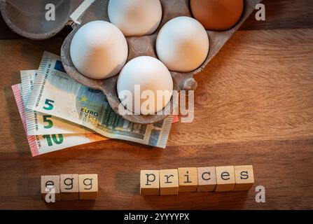 Hausse des prix des œufs, œufs de poulet frais en carton avec billets en euros illustrant l'inflation et l'augmentation des coûts d'épicerie Banque D'Images