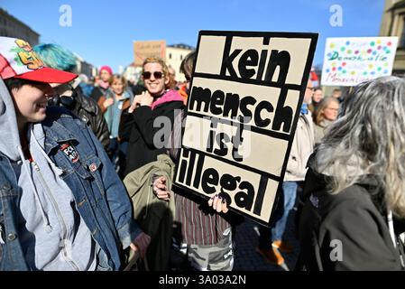Munich, Allemagne. 02 mars 2025. Les participants à la manifestation contre la droite sous le slogan "maintenant plus que jamais - nous resterons forts" tiennent une pancarte "aucun être humain n'est illégal" sur Odeonsplatz. Crédit : Uwe Lein/dpa/Alamy Live News Banque D'Images