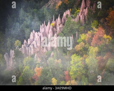 Formations rocheuses des pyramides de Terre dans la brume d'automne, Renon Banque D'Images