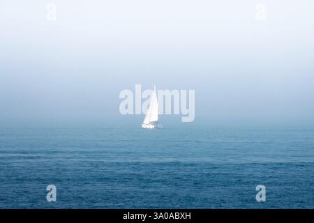 Un bateau sur la mer par temps brumeux Banque D'Images