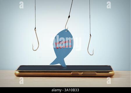 Téléphone portable et hameçons de pêche avec note papier en forme de poisson avec le mot de passe écrit - phishing, vol de données et concept de sécurité Internet Banque D'Images