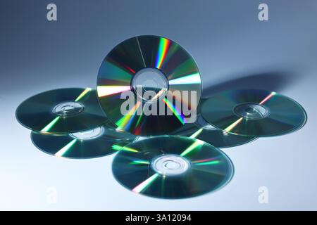 Beaucoup de disques compacts brillants sur fond bleu poussiéreux Banque D'Images