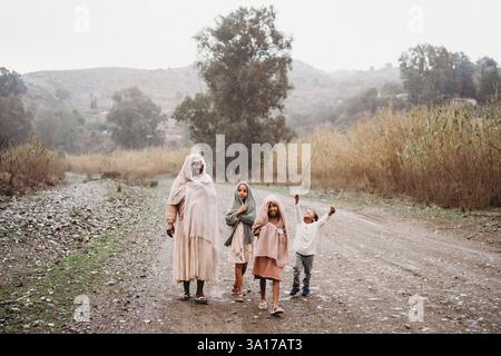 Famille noire marchant dans la campagne couvert jour de maman enceinte enfants Banque D'Images