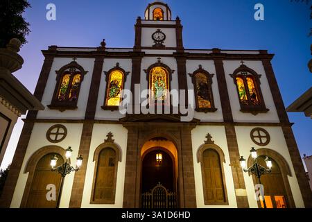 Une grande église avec des vitraux et une horloge sur la tour. Banque D'Images