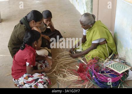 Vieille femme tissant avec des feuilles de palmier à Manappad, Tamil Nadu, Inde, Asie Banque D'Images