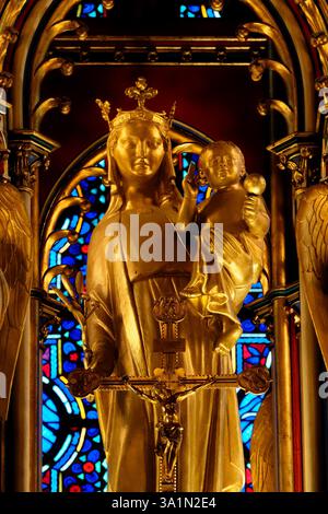 Amiens, FRANCE, 02-15-2025 : statue peinte en or (XIXe siècle) de la Bienheureuse Vierge Marie tenant l'enfant Jésus-Christ dans ses bras. Banque D'Images