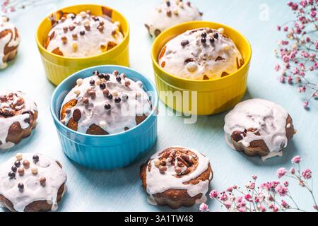 Cupcakes et muffins ou gâteaux de Pâques versés avec glaçage blanc sur une table bleu clair. Espace pour le texte. Vue de dessus. Photo de haute qualité Banque D'Images