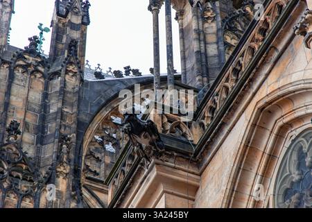02-21-2025, Prague, statue de gargouille surplombant le magnifique paysage urbain de Prague depuis le toit de la cathédrale de la grande Vitus, présentant un style gothique complexe Banque D'Images