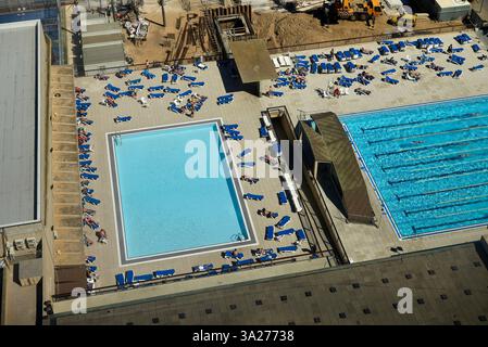 Vue aérienne de deux piscines extérieures avec bains de soleil et chaises longues les jours ensoleillés. Barcelone, Espagne Banque D'Images