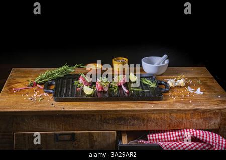 Côtelettes d'agneau crues assaisonnées et marinées aux herbes Banque D'Images