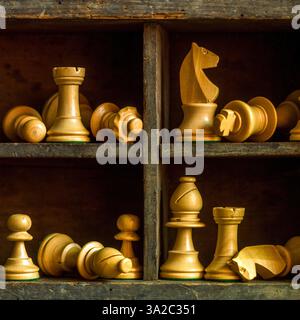 Pièces d'échecs en bois disposées dans une boîte vintage présentant des éléments de jeu stratégiques et de l'artisanat Banque D'Images