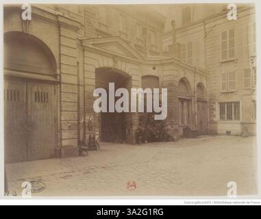 Photographie d’Eugène Atget mettant en valeur la cour de l’Hôtel le Camus, situé rue des Francs-Bourgeois à Paris. L'image capture l'architecture et le caractère historique de cette région à la fin du XIXe siècle. Le travail d’Atget offre un regard détaillé sur les rues et les bâtiments parisiens de l’époque. Banque D'Images